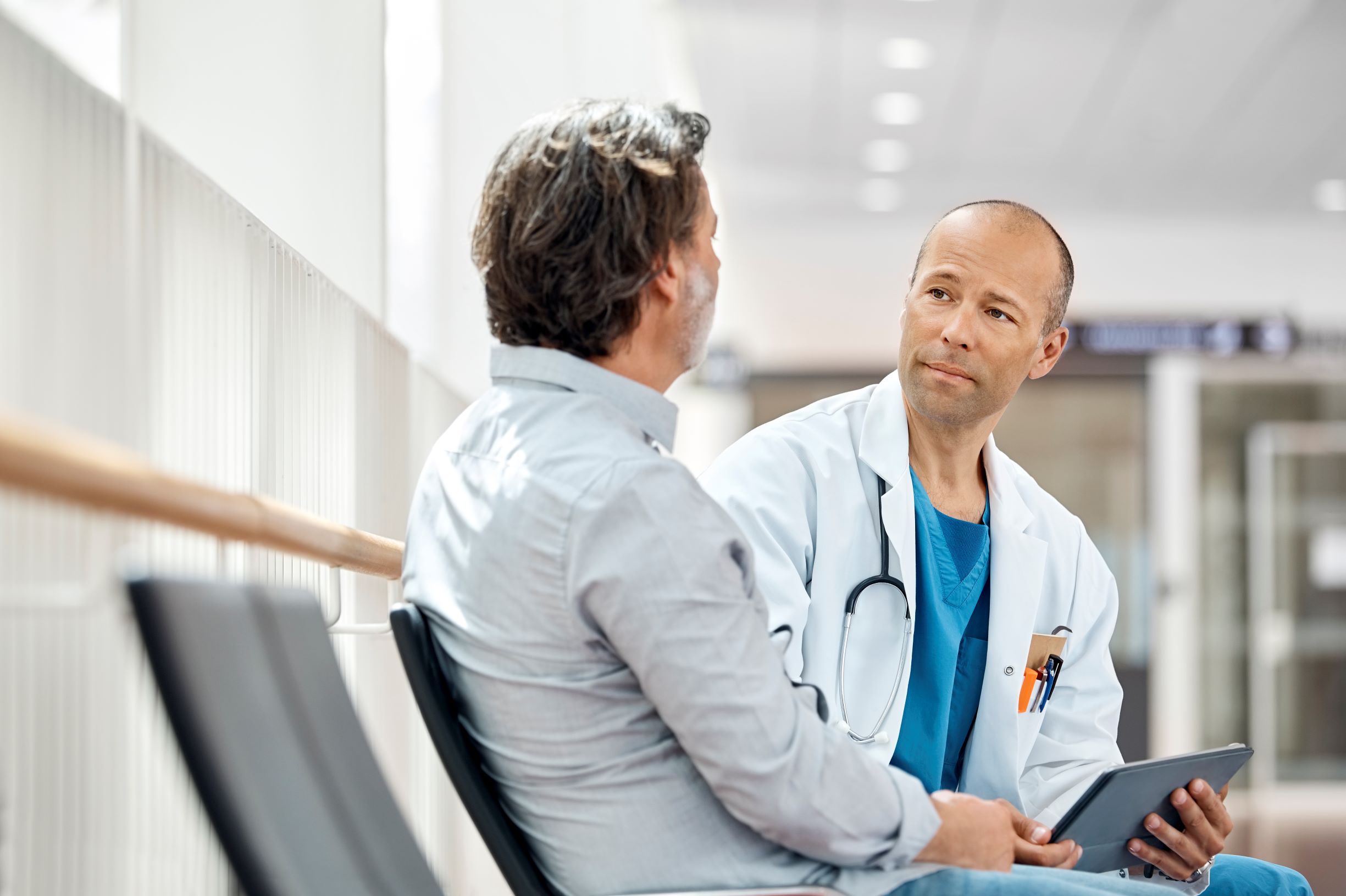 Doctor speaking with older male