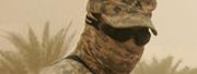 Closeup of soldier in goggles and camouflage with fabric  covering face in the  desert.
