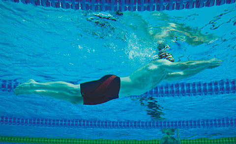 male swimming in swimming lane