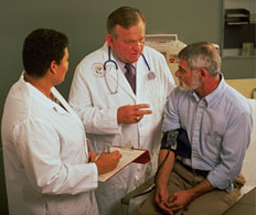 Two doctors examining a patient