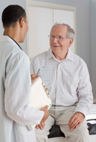 Doctor talking to older male patient