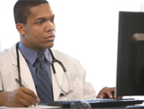 Medical professional reading text on computer screen